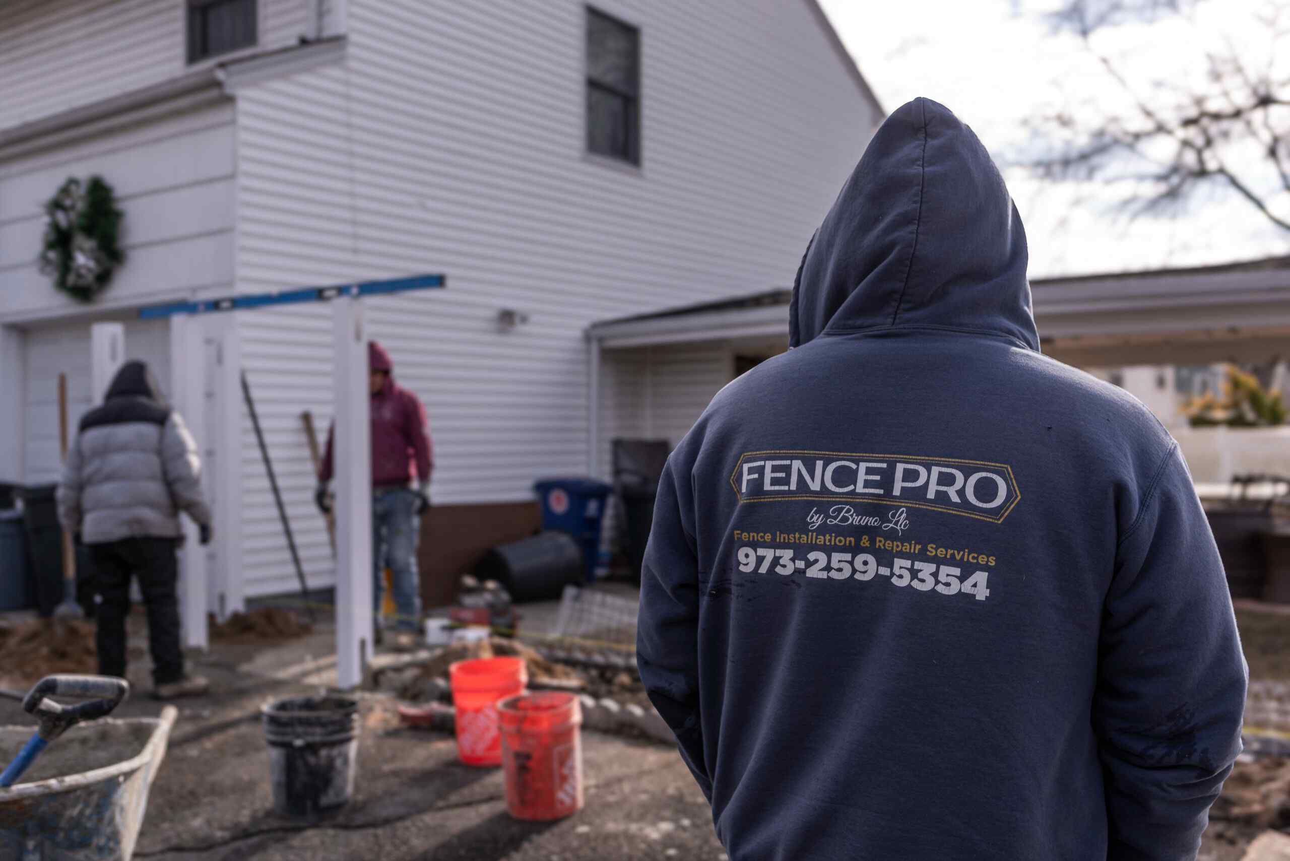 Fence Pro by Bruno installer in branded hoodie overseeing a fence repair